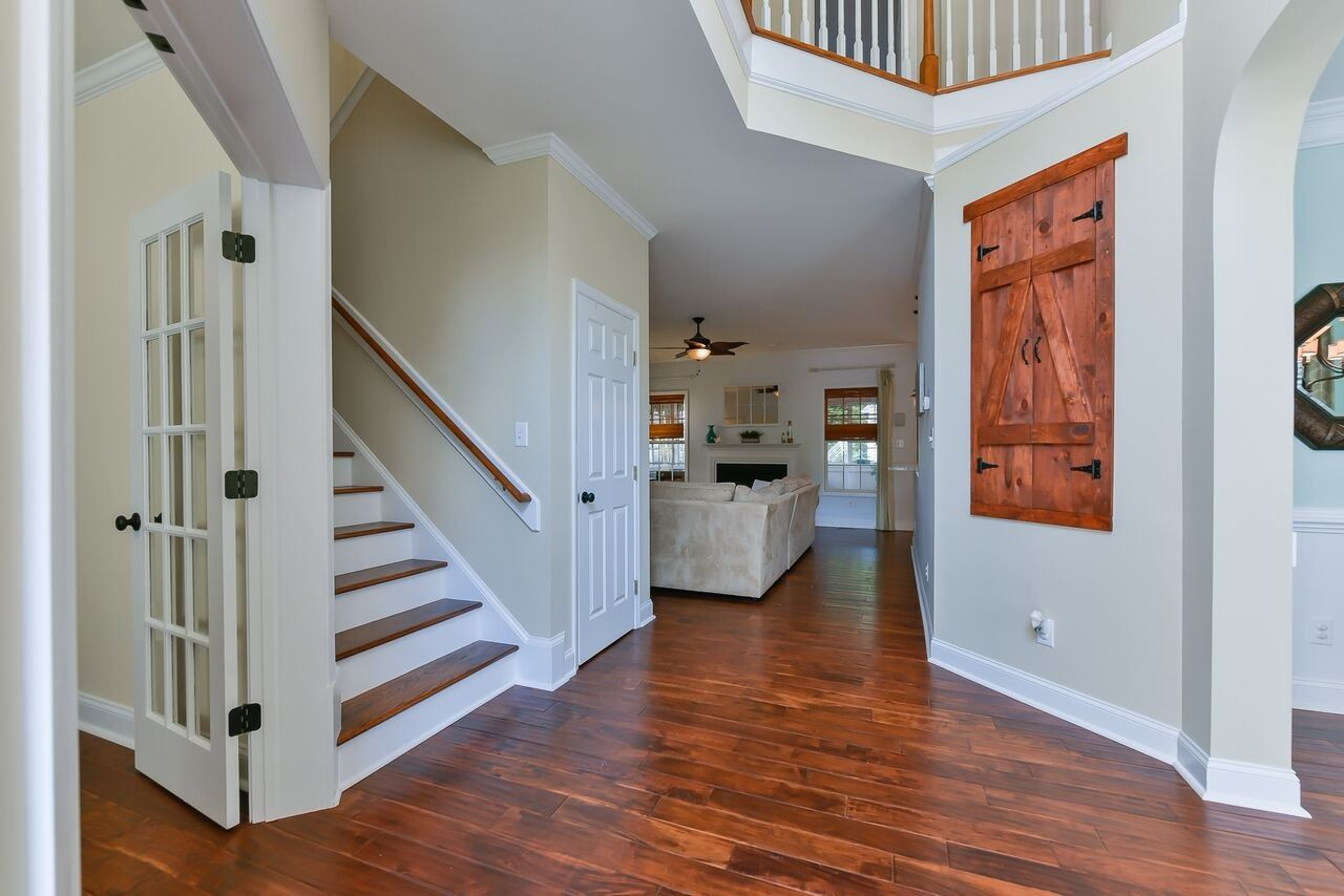 5529 Rush Springs Court Raleigh, NC 27617 - Photo 2 of 14 Not a detail missed!! Be welcomed by HANDSCRAPED wide plank TEAK WOOD FLOORS & 2-story foyer. SOOOO many updates! foyer