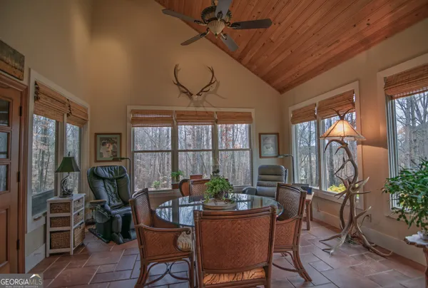 a bathroom with a toilet a sink a mirror and a window
