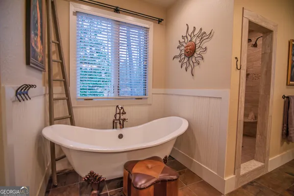 a front view of a house with a yard and potted plants