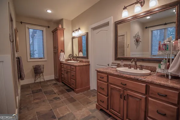 a front view of a house with a garden and plants