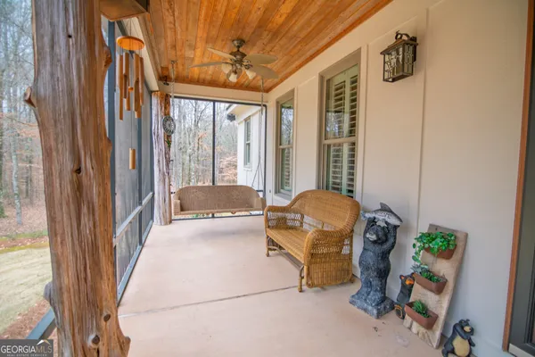 a living room with furniture a ceiling fan and a rug