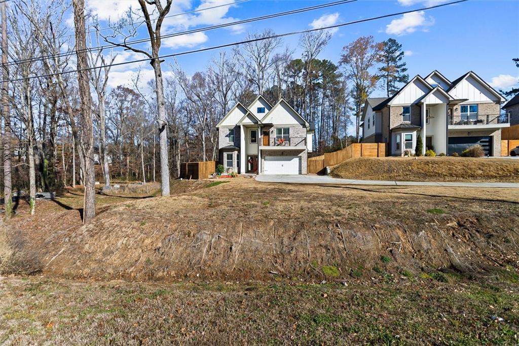 658 Rockbridge Road Northwest Lilburn, GA 30047 - Photo 48 of 61 a front view of a house with a yard