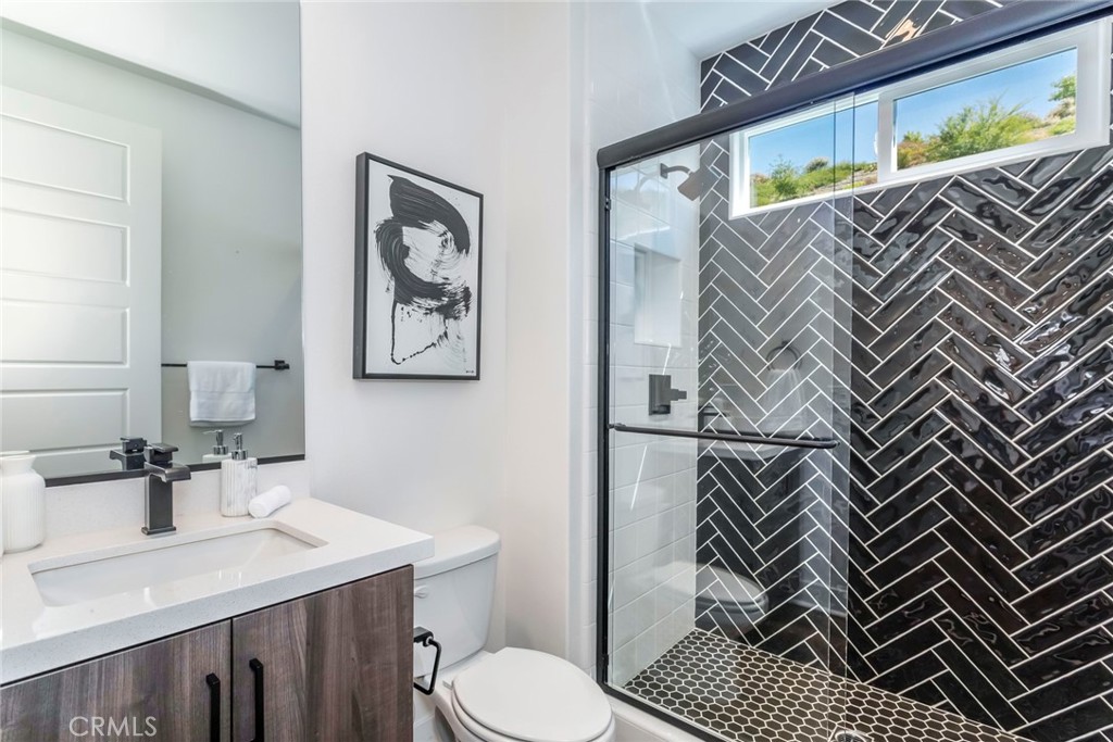 17701 Ridgeline Court Saugus, CA 91350 - Photo 17 of 61 a bathroom with a sink mirror vanity and toilet