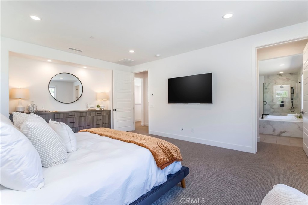 17701 Ridgeline Court Saugus, CA 91350 - Photo 26 of 61 a bedroom with a bed a mirror and a flat screen tv