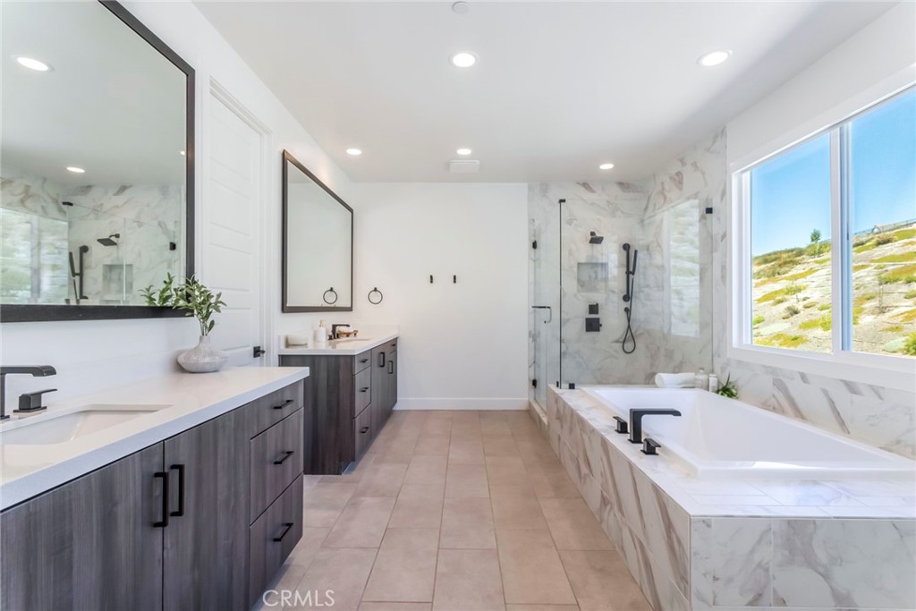 17701 Ridgeline Court Saugus, CA 91350 - Photo 29 of 61 a large bathroom with a double vanity sink large mirror and a bathtub