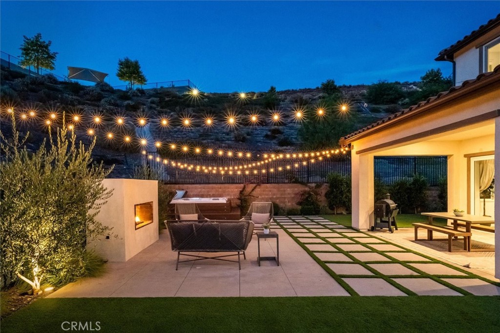 17701 Ridgeline Court Saugus, CA 91350 - Photo 41 of 61 a view of a patio with dining table and chairs with a fire pit