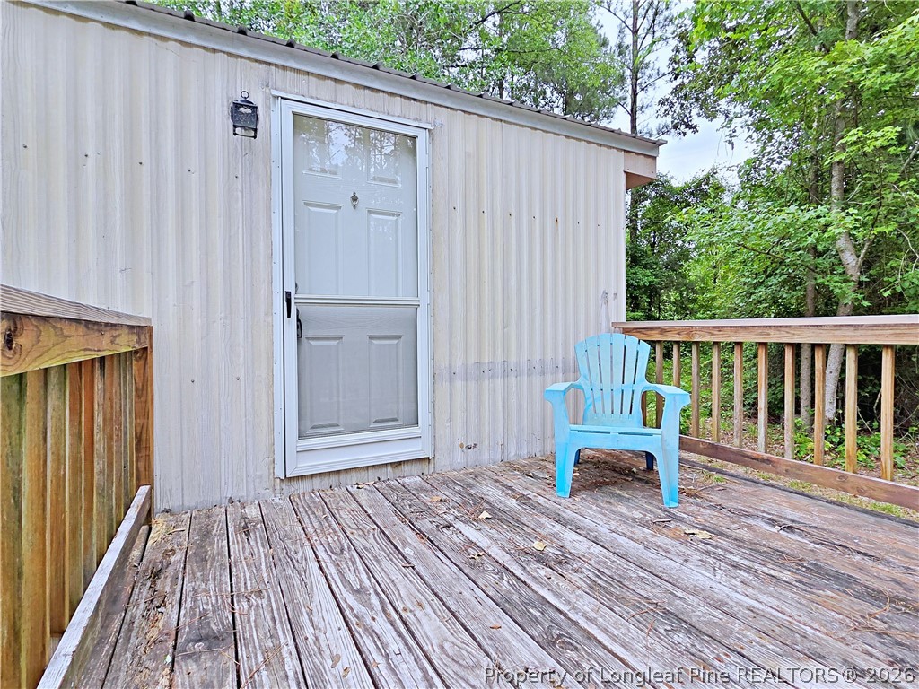 1031 Pine Acres Road White Oak, NC 28399 - Photo 2 of 29 a view of a wooden deck