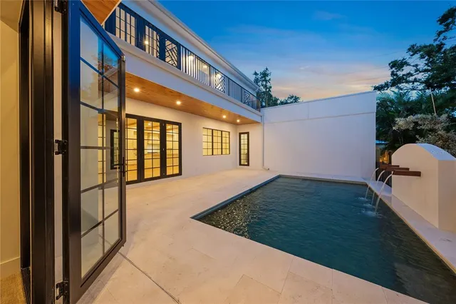 a view of a hallway with wooden floor and entryway