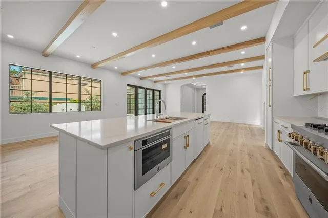 a large white kitchen with a sink