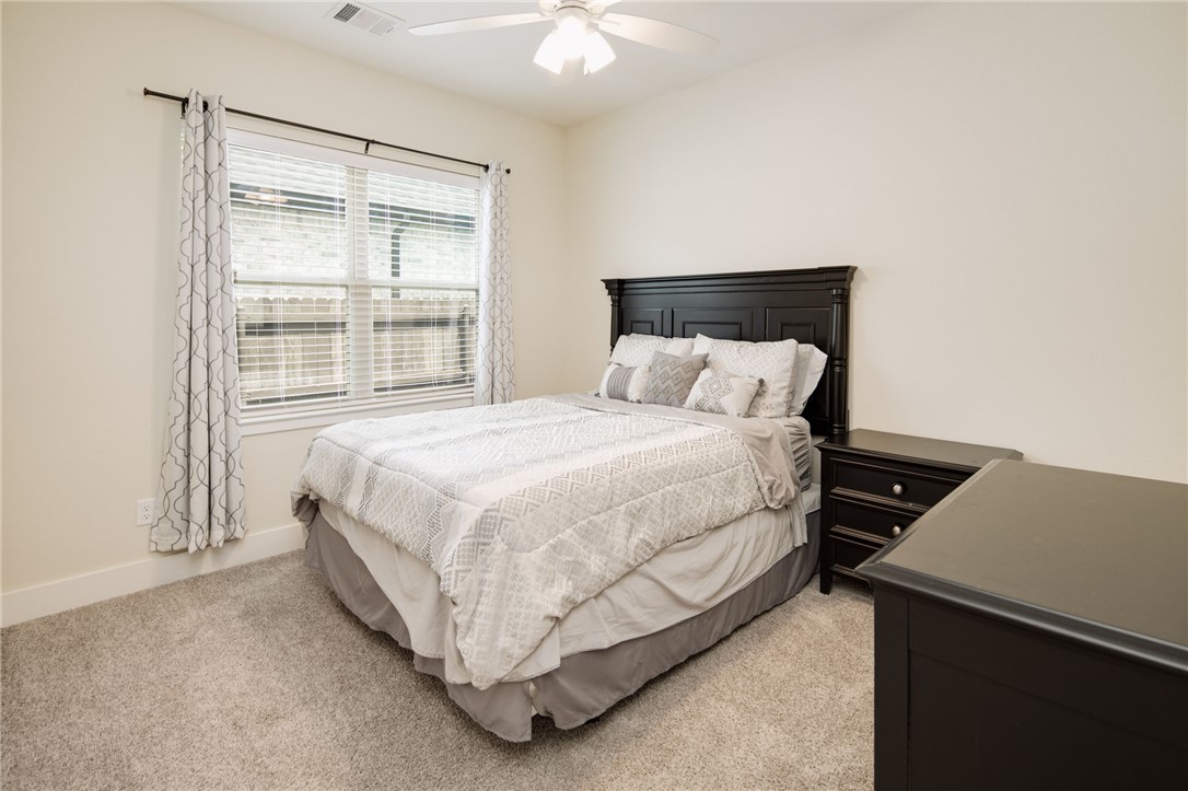4302 Appalachian Trail Bryan, TX 77802 - Photo 17 of 23 Bedroom featuring light carpet, ceiling fan, and b