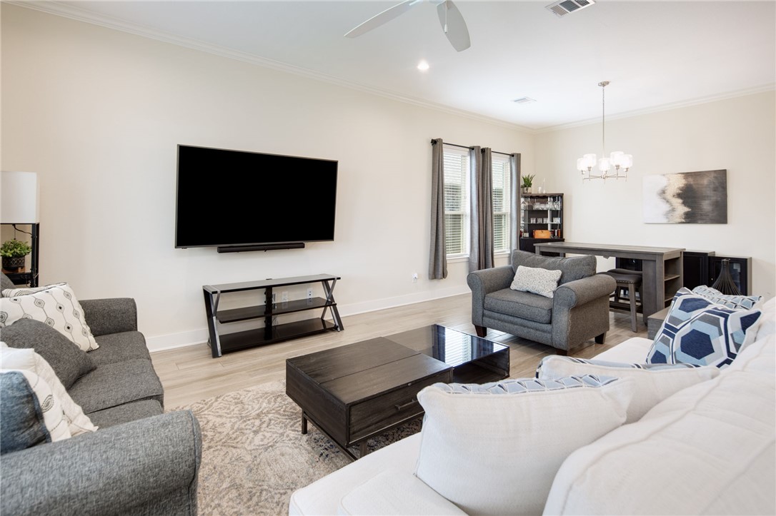 4302 Appalachian Trail Bryan, TX 77802 - Photo 5 of 23 Living room with a chandelier, light wood-type flo