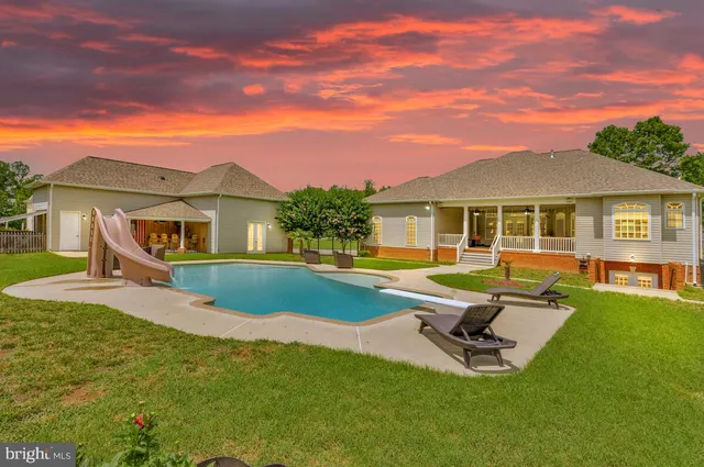 a view of a house with swimming pool and porch