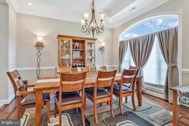 a view of a dining room with furniture and chandelier