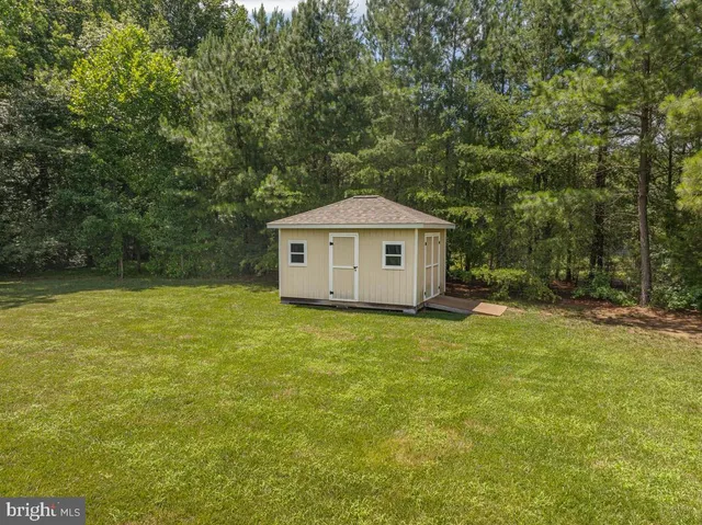 a view of a house with swimming pool and a yard