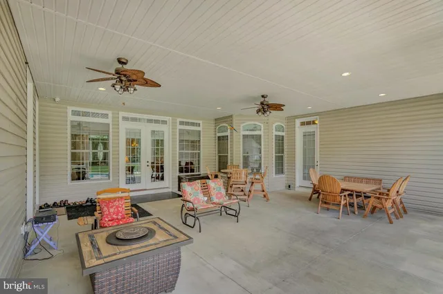 a living room with furniture ceiling fan and a rug