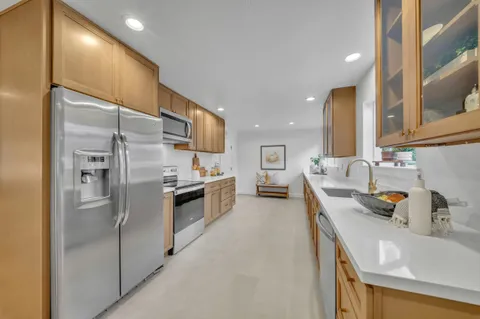 a kitchen with stainless steel appliances a refrigerator and a sink