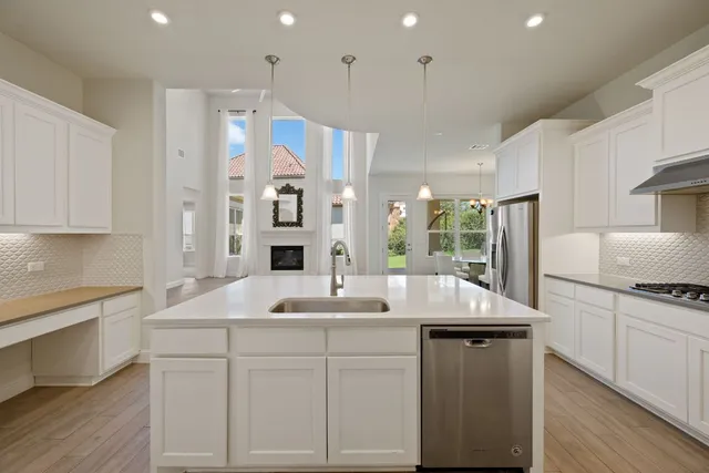 a kitchen with a sink window and cabinets
