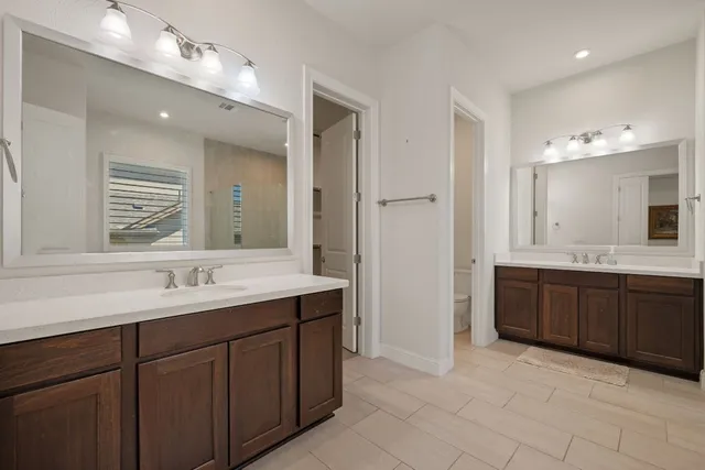 a spacious bathroom with a tub sink shower and mirror