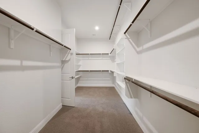 a bathroom with a granite countertop double vanity sink a mirror and a