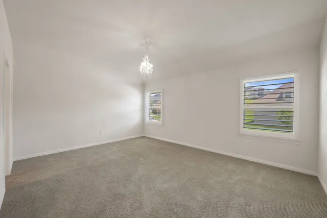 a bathroom with a granite countertop sink a toilet a mirror a bathtub and shower