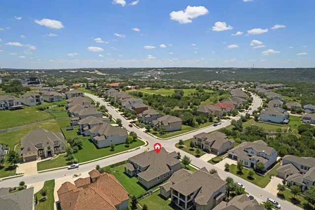 an aerial view of residential houses with outdoor space