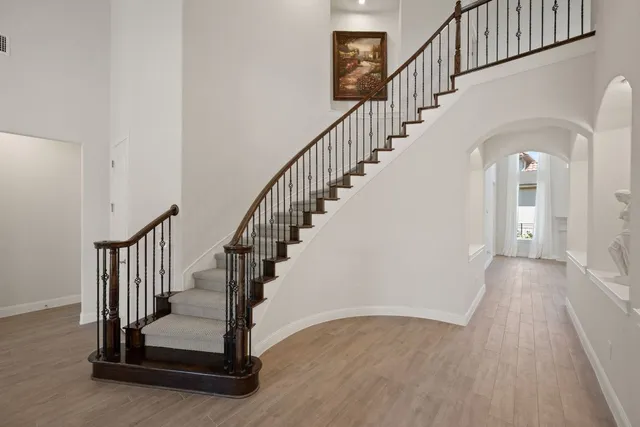 a view of staircase with wooden floor and a rug