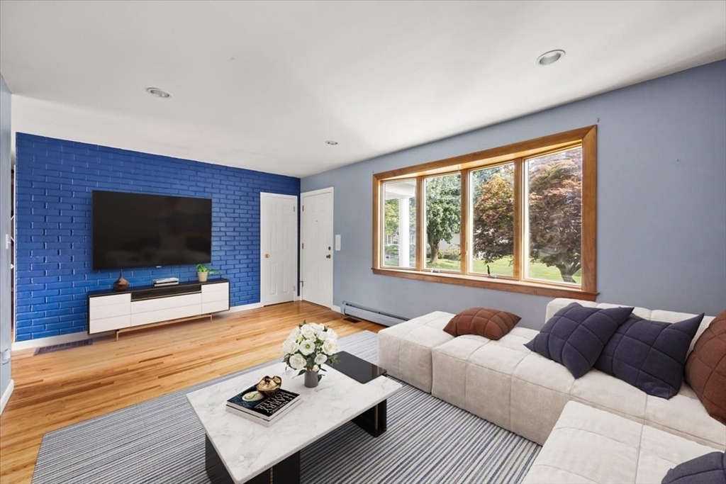 82 Midland Road Somerset, MA 02726 - Photo 7 of 28 a living room with furniture a flat screen tv and a large window