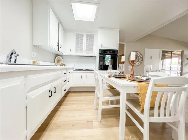 a kitchen with stainless steel appliances kitchen island granite countertop a sink and cabinets