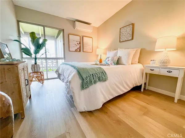 a bedroom with a bed and wooden floor