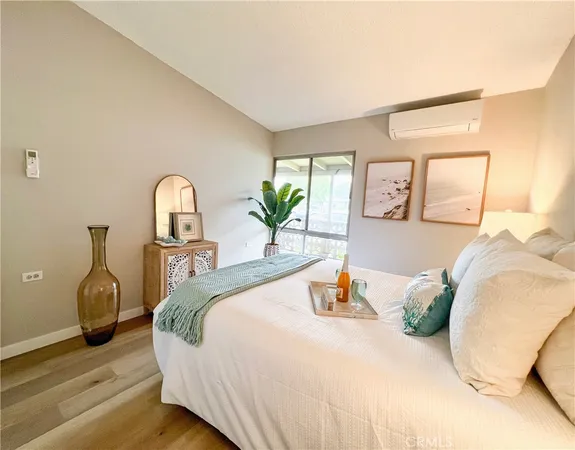a bedroom with bed and wooden floor