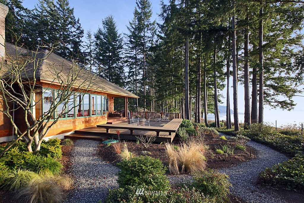 6966 Sills Road Clinton, WA 98236 - Photo 2 of 25 a backyard of a house with yard fountain and outdoor seating