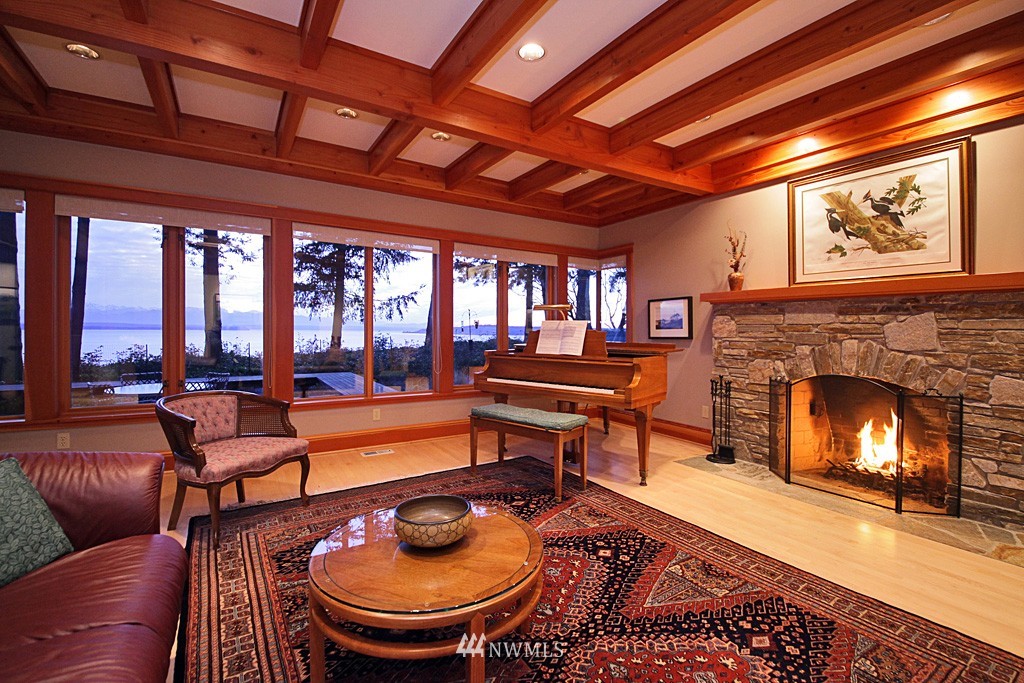 6966 Sills Road Clinton, WA 98236 - Photo 11 of 25 a living room with furniture and a fireplace