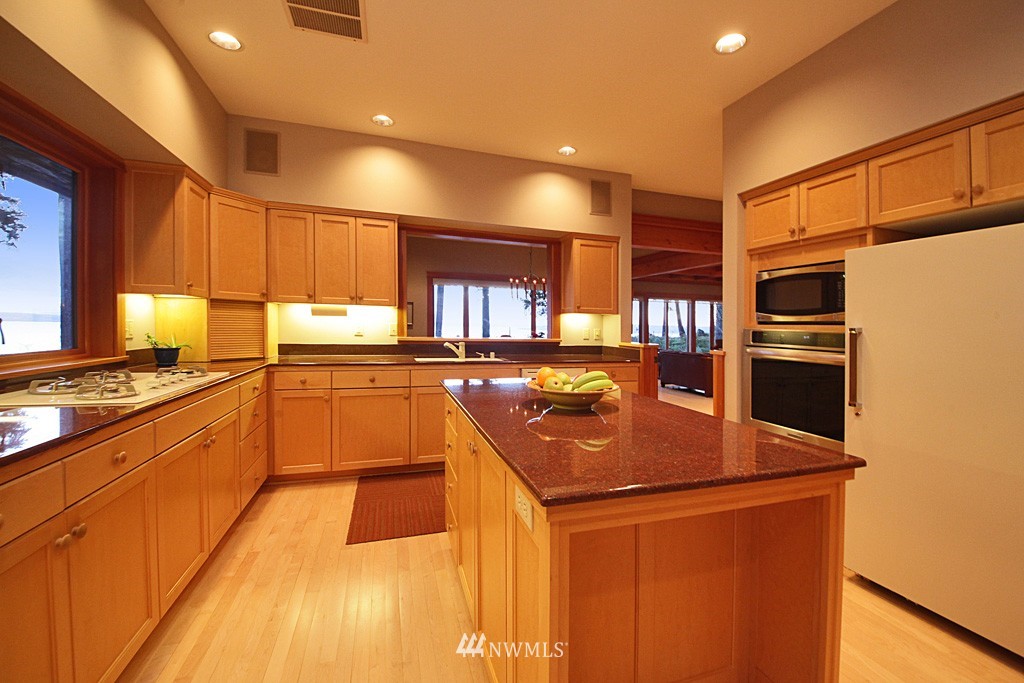 6966 Sills Road Clinton, WA 98236 - Photo 15 of 25 a kitchen with stainless steel appliances granite countertop a sink a stove and a refrigerator
