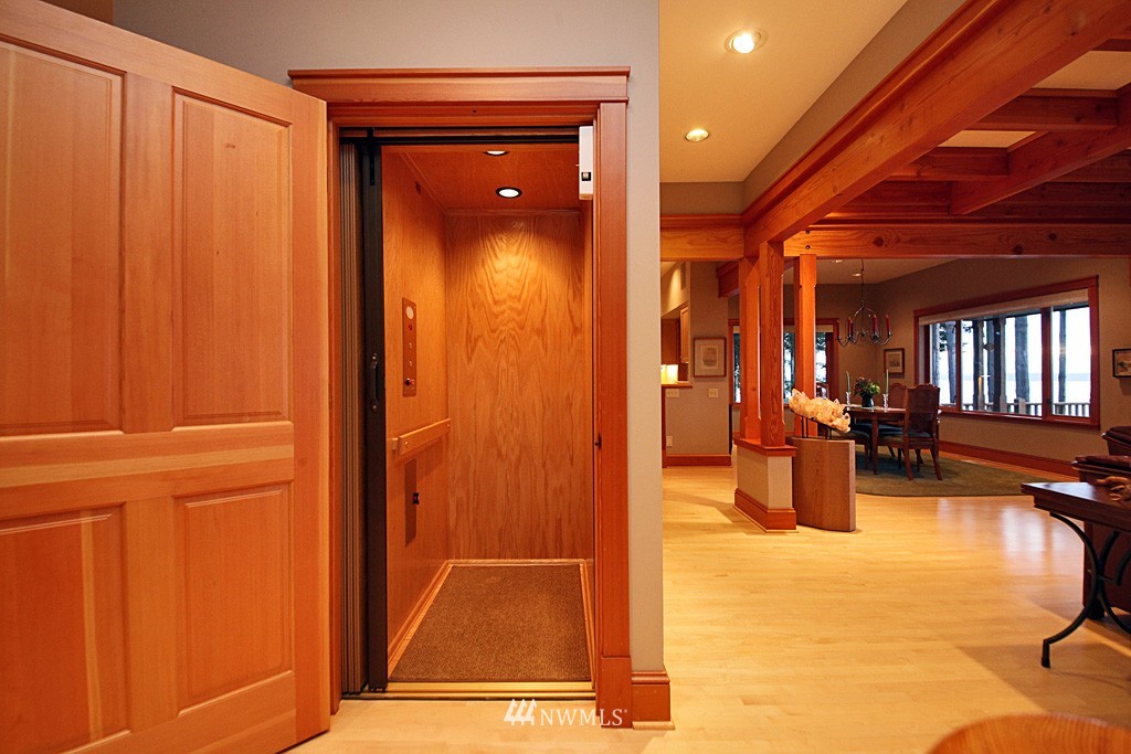 6966 Sills Road Clinton, WA 98236 - Photo 20 of 25 a view of a hallway with couch and chandelier