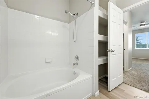 a bathroom with a bathtub and a shower