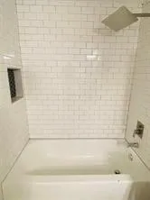 a bathroom with a toilet and shower