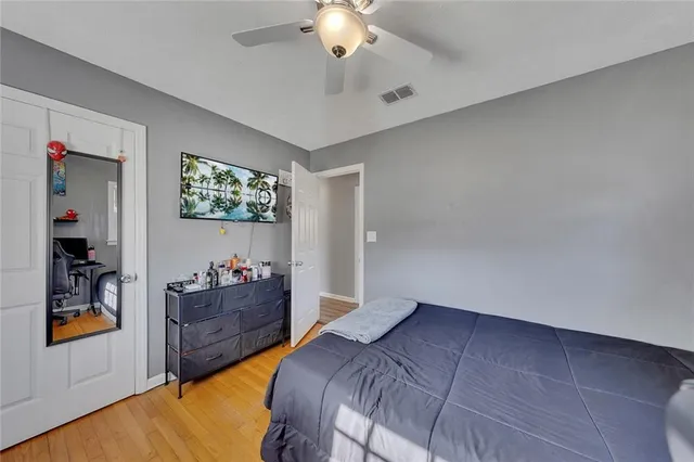 a bedroom with bed and a chandelier