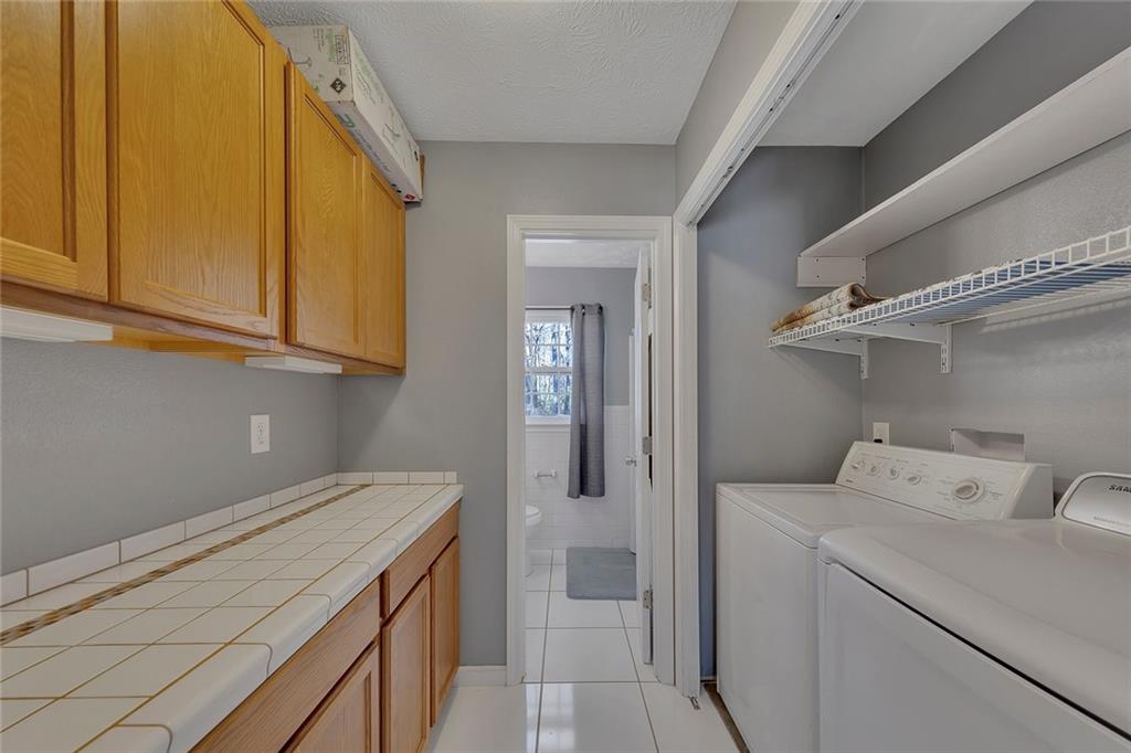 4385 Donegal Circle Lithia Springs, GA 30122 - Photo 20 of 32 a utility room with dryer and washer