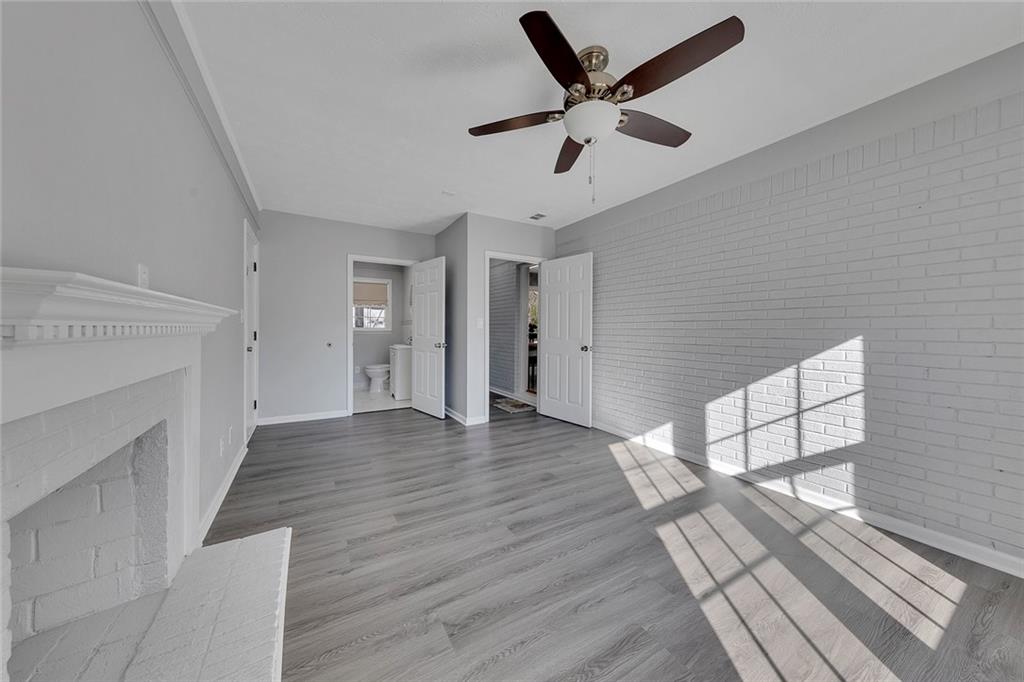 4385 Donegal Circle Lithia Springs, GA 30122 - Photo 24 of 32 wooden floor in an empty room with a fireplace