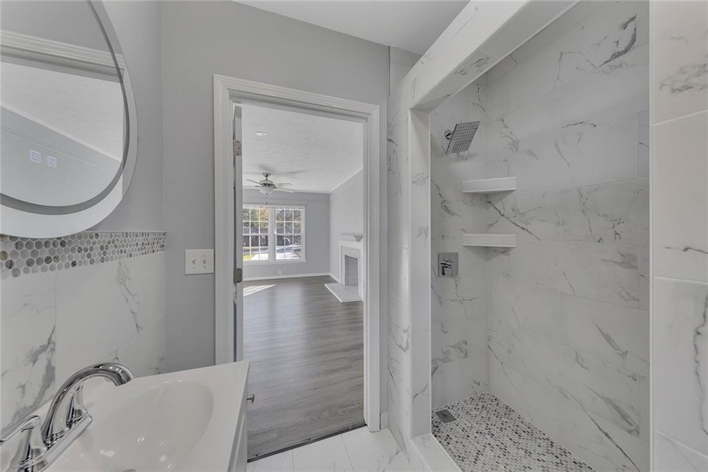 4385 Donegal Circle Lithia Springs, GA 30122 - Photo 26 of 32 a bathroom with a sink a toilet and shower