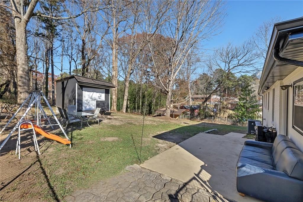 4385 Donegal Circle Lithia Springs, GA 30122 - Photo 27 of 32 a view of a patio with couches table and chairs and potted plants