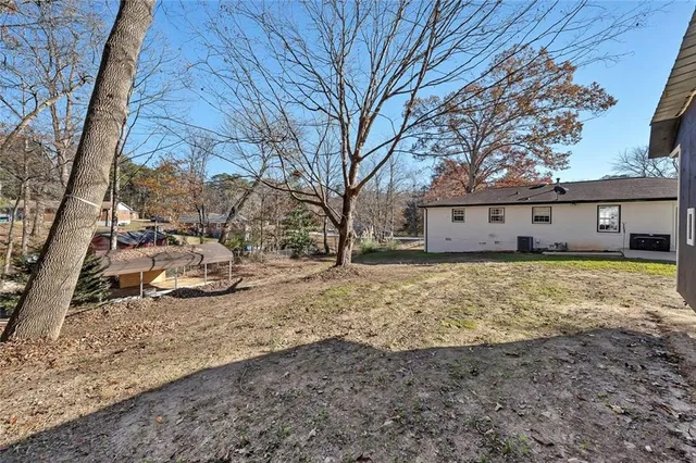 a view of a yard with wooden fence