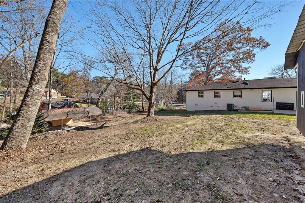 4385 Donegal Circle Lithia Springs, GA 30122 - Photo 28 of 32 a view of a yard with wooden fence