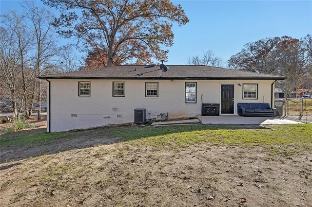 a view of a backyard with a garden and fire pit