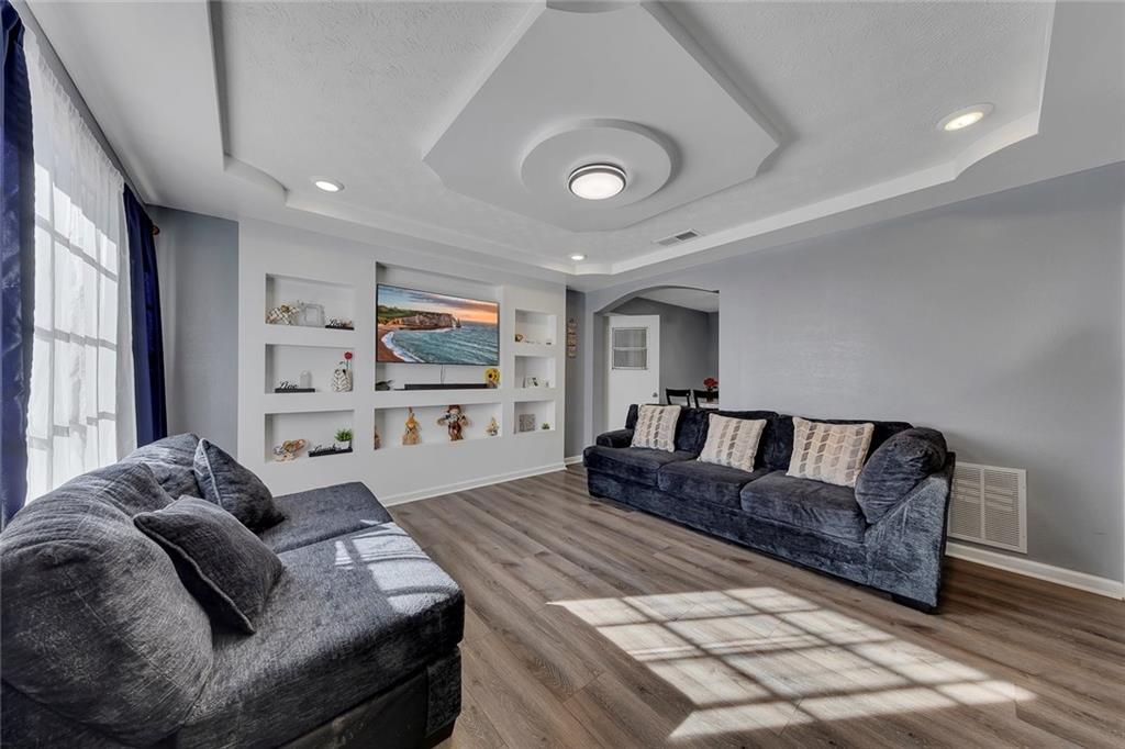 4385 Donegal Circle Lithia Springs, GA 30122 - Photo 7 of 32 a living room with furniture and a flat screen tv