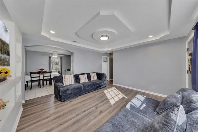 a living room with furniture and wooden floor