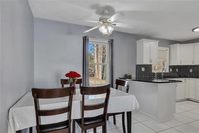 a view of a dining room with furniture and chandelier