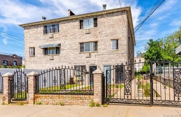 a view of a brick house with large windows