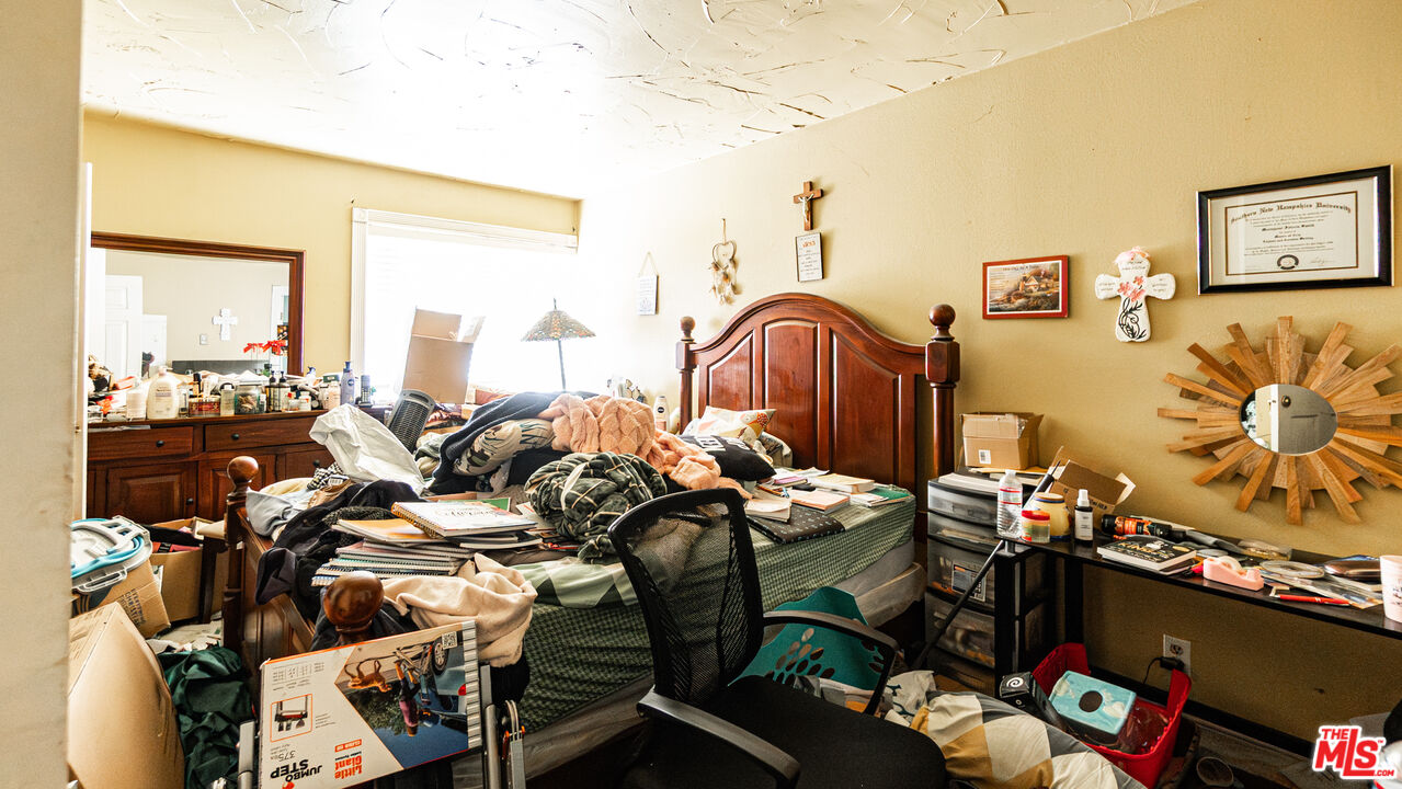 5500 Ackerfield Avenue, Unit 104 Long Beach, CA 90805 - Photo 12 of 19 a bedroom with furniture and a window