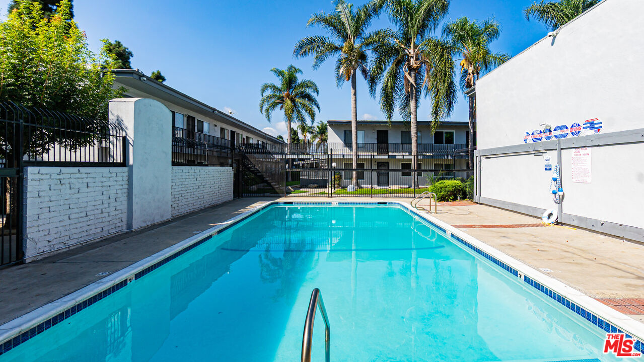 5500 Ackerfield Avenue, Unit 104 Long Beach, CA 90805 - Photo 17 of 19 a swimming pool with outdoor seating and yard